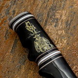 The handle is crafted from polished bull horn and features a deeply Scrimshaw engraved western scene finished in warm golden tones.