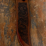 closeup of the engraved dragon artwork on leather sheath