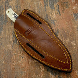 The sheath features reinforced stitching along the edges and dual belt slots for secure horizontal carry.
