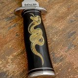 The handle is crafted from polished black bull horn, offering a deep glossy surface that highlights the natural richness of the material