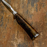 Wooden-handled knife with metal blade on a textured brown background