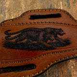 Leather pouch with a leopard design on a wooden background