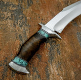 A custom fixed-blade knife with a polished silver steel blade, a contoured dark brown wooden handle, and turquoise inlay accents, Stainless Steel guard and But cap