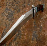 A large curved fixed-blade bowie knife with a satin-finished silver D2 blade, Stainless Steel guard, and a dark brown handle with turquoise Gemstone accents