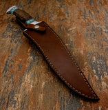 A fixed-blade knife with a dark brown handle and turquoise-colored bolster, resting diagonally inside a brown leather sheath, Buy from UK knife store