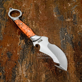 A custom fixed-blade Skinning Gut hook knife with a polished silver D2 blade and a textured orange Gemstone handle with black crackle detailing