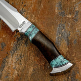 A close-up of a fixed-blade knife with a satin-finished silver blade, a dark brown wood handle, and turquoise gemstone inlay accents, Steel fittings