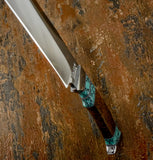 A close-up diagonal shot of a knife with a satin-finished silver blade and a decorative handle featuring turquoise and dark brown wood, buy from UK Knife store