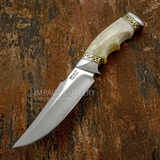 A fixed-blade knife from UK store, with a curved D2 blade, a cream-colored bone handle, and gold-toned file worked metal accents
