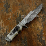 The blade features dramatic, flowing Damascus patterning that moves from spine to edge in layered waves, creating a striking visual depth.