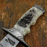 Matching Damascus steel guard and pommel continue the layered pattern seamlessly, creating a cohesive, high-end presentation.
