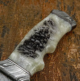 Embedded within the handle is an intricately engraved tall sailing ship artwork, detailed with masts, sails, rigging, and surrounding water texture