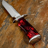 A fixed-blade Survival hunting knife with a satin-finished silver D2 blade and a polished red Marbled resin handle