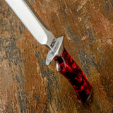 A diagonal close-up view of a fixed-blade Survival knife with a D2 blade and a glossy red marbled resin  handle