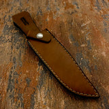 A brown leather knife sheath with visible stitching and a silver snap button, Buy from UK knife Shop