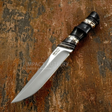A fixed-blade knife with a satin-finished D2 steel blade and a black handle featuring geometric Brass inlays, individually shaped with sculpted sections