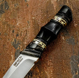 A close-up of a custom fixed-blade knife with a silver D2 blade The polished bull horn handle is individually shaped with sculpted sections and fine decorative brass fileworks. Detailed finishing around the pommel further emphasizes the handmade character of the piece