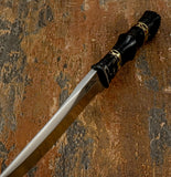 A close-up of blade top view of decorative Knife with a polished silver blade and a black handle with Fileworked Brass spacers