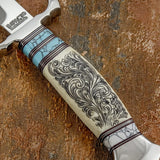 closeup of handle combines camel bone with turquoise-coloured gemstone accents, separated by fine contrasting spacers. The cream-toned camel bone features elaborate flowing scrollwork that follows the curvature of the handle.
