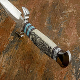 Additional pale gemstone detailing near the pommel and richly polished fittings create further contrast, while the shaped handle provides a graceful transition from pommel to guard.
