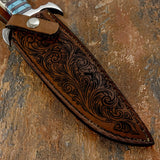 Closeup of the engraved leather sheath with scrollwork