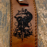 Strong dark linework and shading give the scene weight and dimension, while the stitched border frames the artwork neatly
