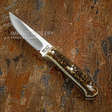 A fixed-blade bushcraft knife with a satin-finished steel blade and a textured stag antler handle