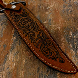 Closeup of Kingsmarch Bowie's leather sheath showing engraved scrollwork on the leather