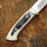 The handle is crafted from deeply engraved camel bone, presenting a detailed illustration of an alligator stretching along the length of the handle