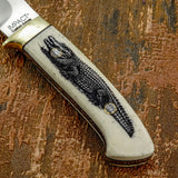 The natural light tone of the camel bone provides strong contrast for the dark engraving, allowing the detailed reptile design to stand out clearly