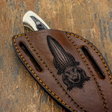 The scene is centered along the sheath and framed by reinforced edge stitching that enhances both durability and visual structure.