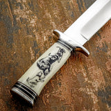 The detailed engraving on the camel bone handle depicts an intense hunting moment between dogs and a wild boar