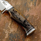 The engraving flows naturally along the curvature of the handle, enhanced by the warm grain patterns of the rosewood.