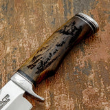 Polished metal spacers at the guard and pommel provide visual contrast and reinforce the refined craftsmanship of the handle.
