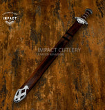 Decorative sword with wooden handle and silver blade on a textured brown background, featuring 'Impact Cutlery' branding.