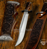 custom Bowie designed for collectors who appreciate traditional knife patterns enhanced with premium materials and detailed artwork. Featuring a satin-finished D2 tool steel blade, engraved Rosewood handle, Damascus fittings, and a matching engraved leather sheath, Dragonmere combines historic Bowie styling with distinctive craftsmanship.
