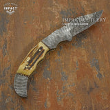 Knife with a Stag Antler handle on a textured brown background, branded 'Impact Cutlery Uk'.