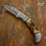 Handmade knife Featuring a hand-forged Damascus steel blade with flowing pattern lines, sculpted Damascus bolsters