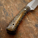 The material displays layered patterns that resemble branching organic textures, with deep earthy browns, amber tones, and lighter natural highlights flowing through the handle.