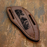 Fine engraved lines add texture to the wolves’ fur and surrounding landscape, giving the artwork a hand-illustrated character.
